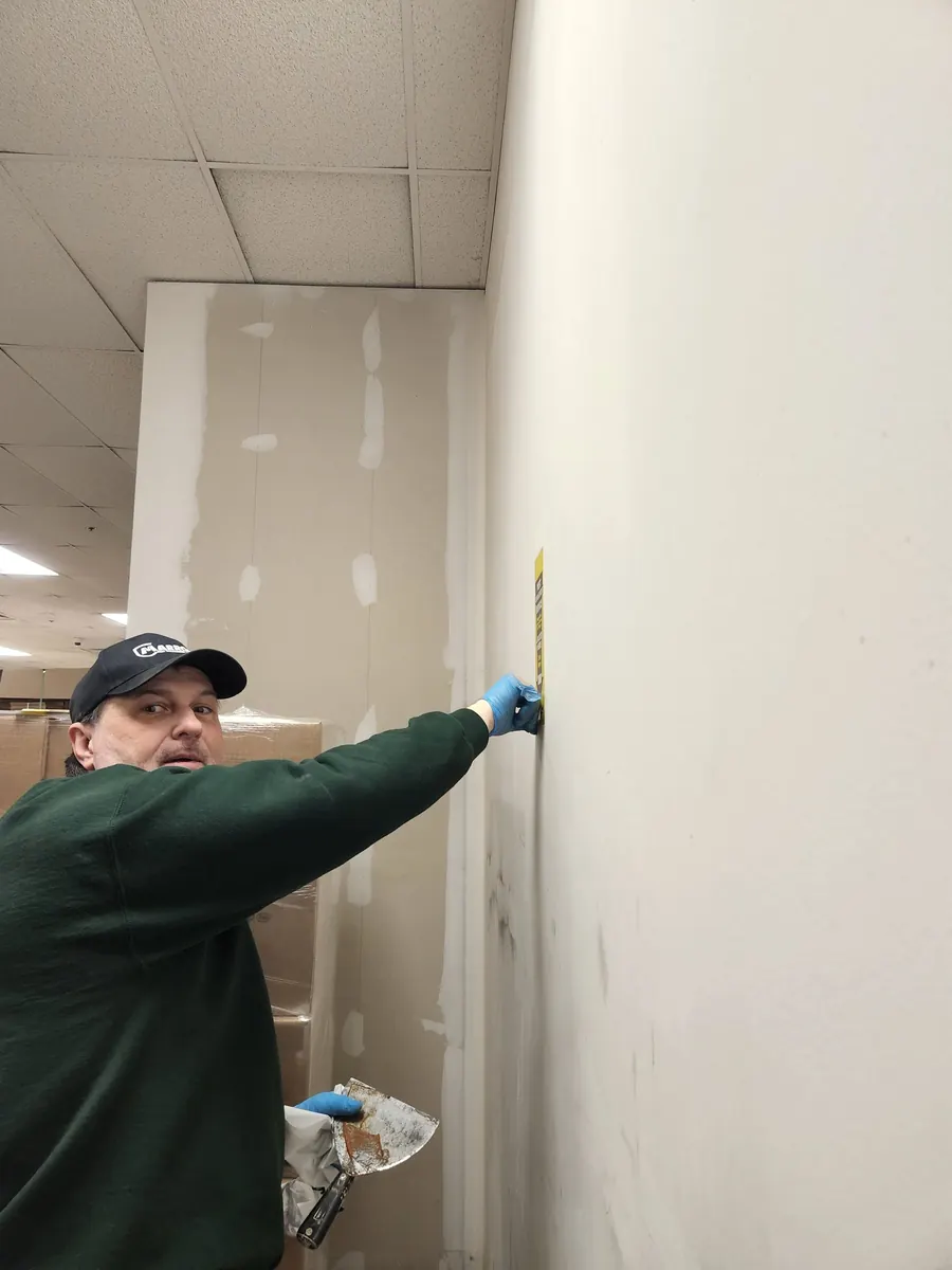 A Marrone technician inspecting a wall for signs of pest activity