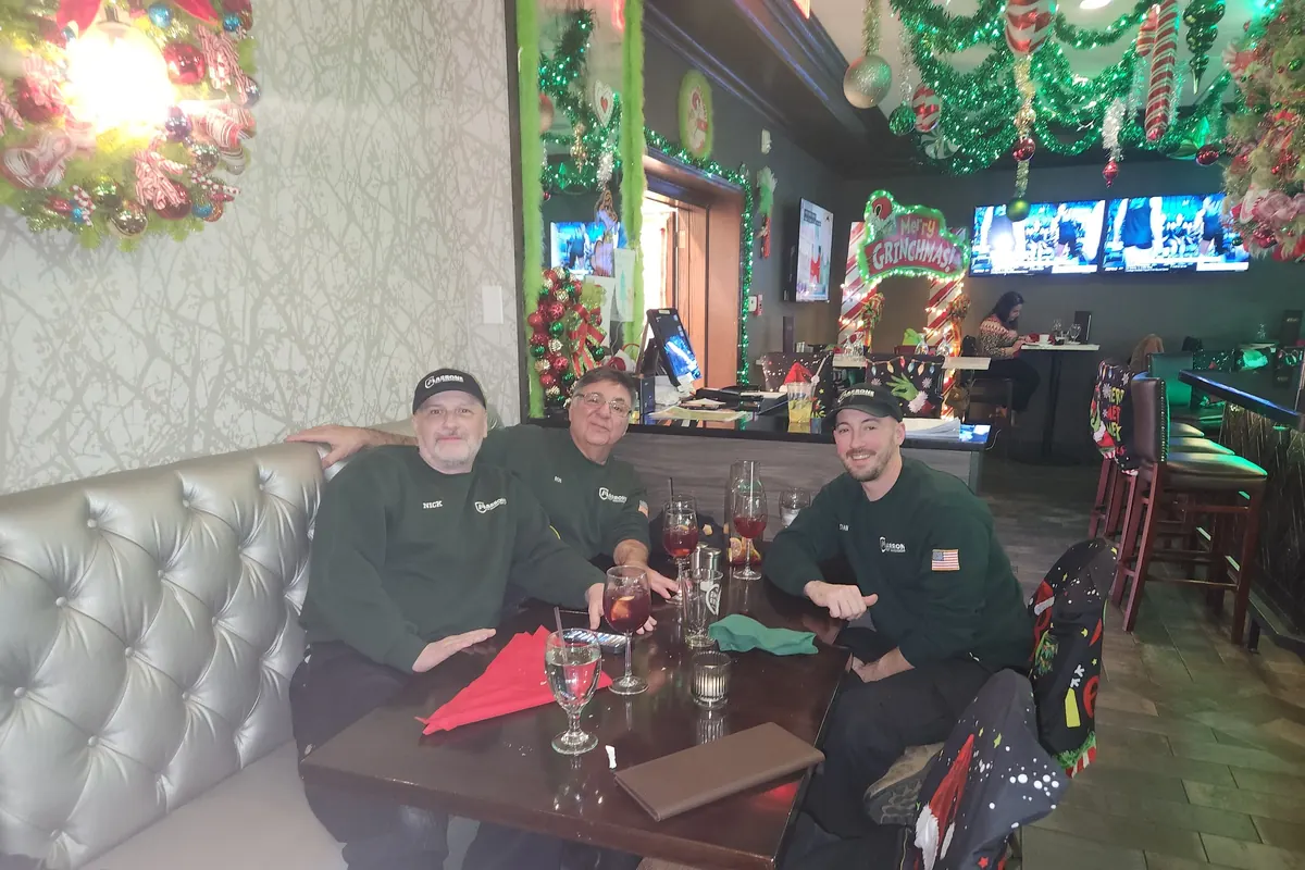 Three Marrone team members in a restaurant booth