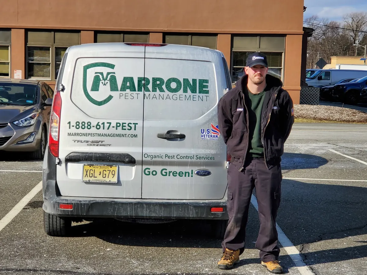 A Marrone technician beside the rear of a company service van